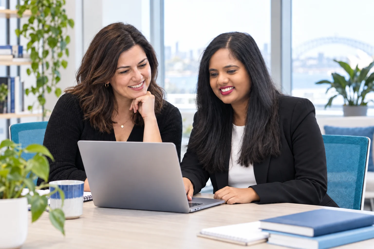 Illustrative generated scene of Karishma and a colleague reviewing a solution together